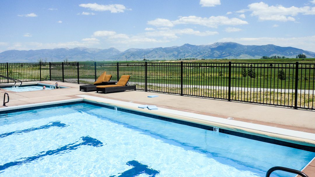 Ameristar Montage Plus ornamental aluminum fence surrounding a backyard pool