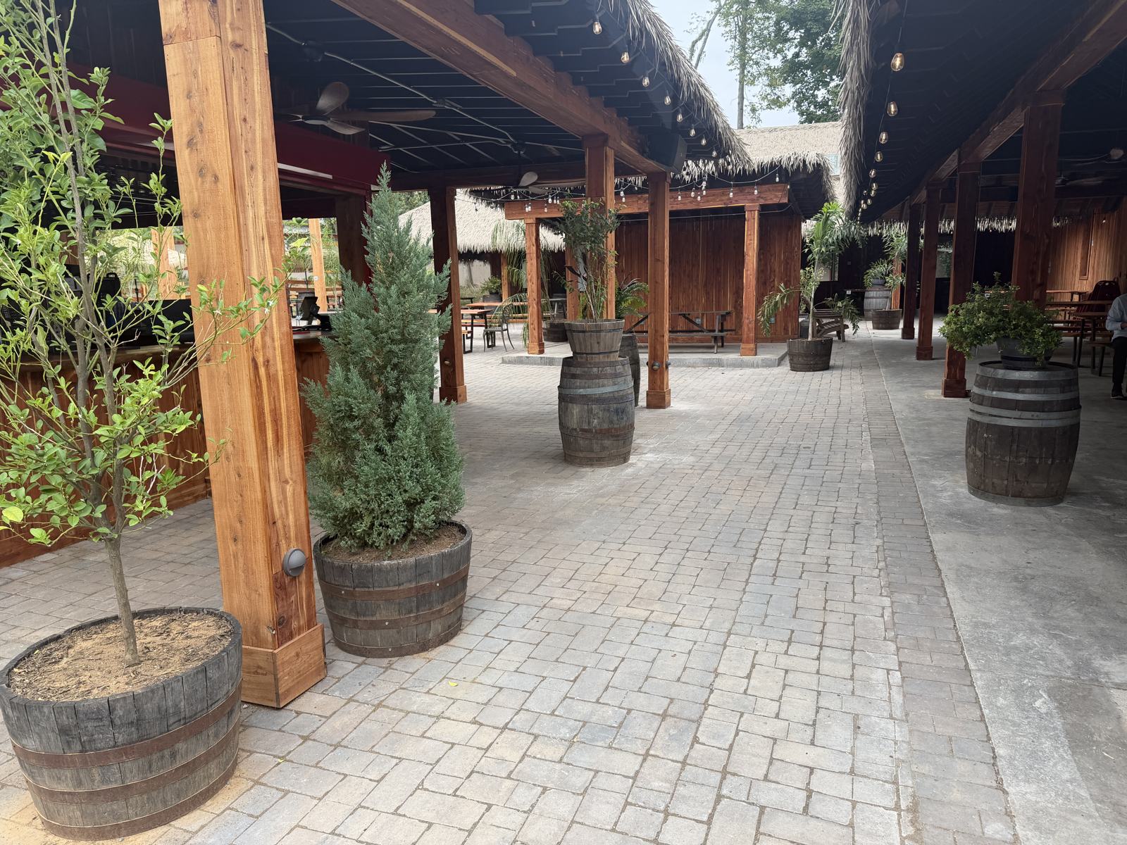 Paver walkway between the bar and the cedar pavilion with juniper planters