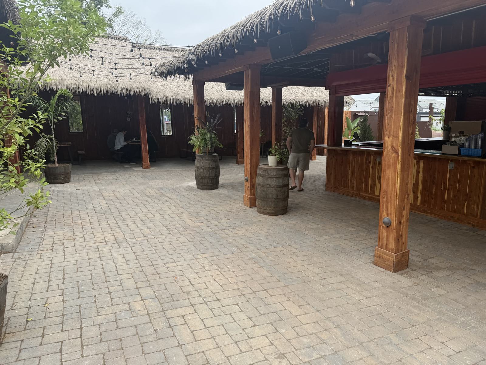 Paver apron in front of the bar under the thatched roof