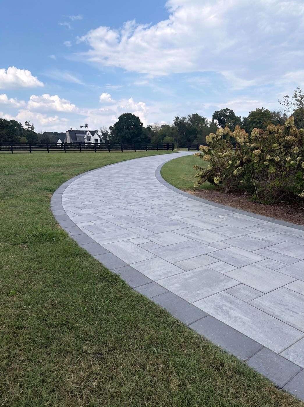 Concept render of Techo-Bloc Blu 60 Smooth paver overlay on a curved driveway in Franklin TN