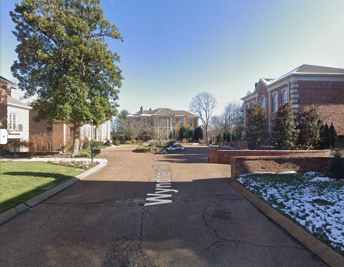 Aging asphalt HOA entrance drive in Nashville before paver overlay