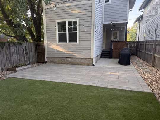 Concept render of a Unilock Beacon Hill paver patio with soldier-course border in an East Nashville backyard